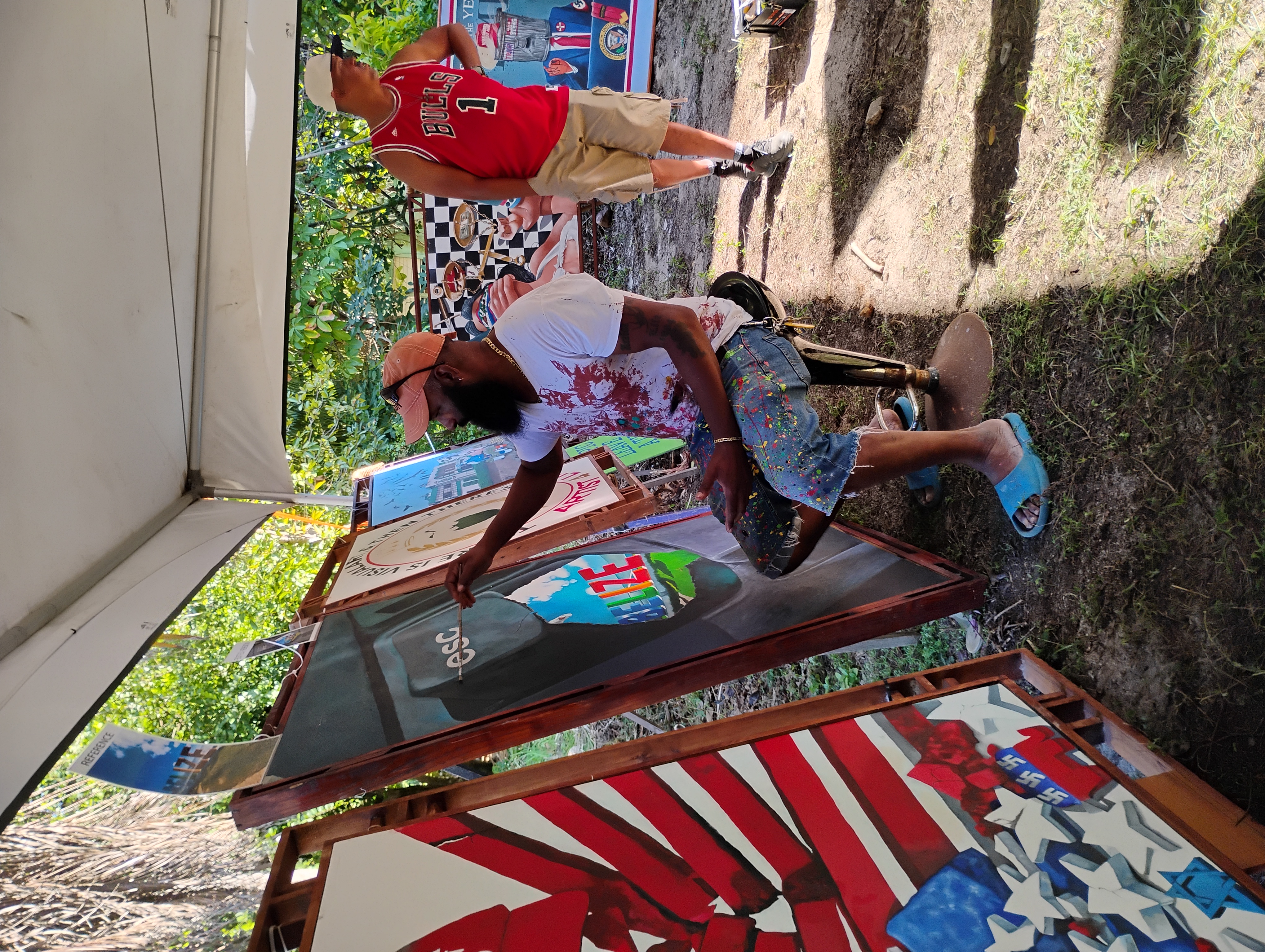 Alex Sanker working a new painting at his booth