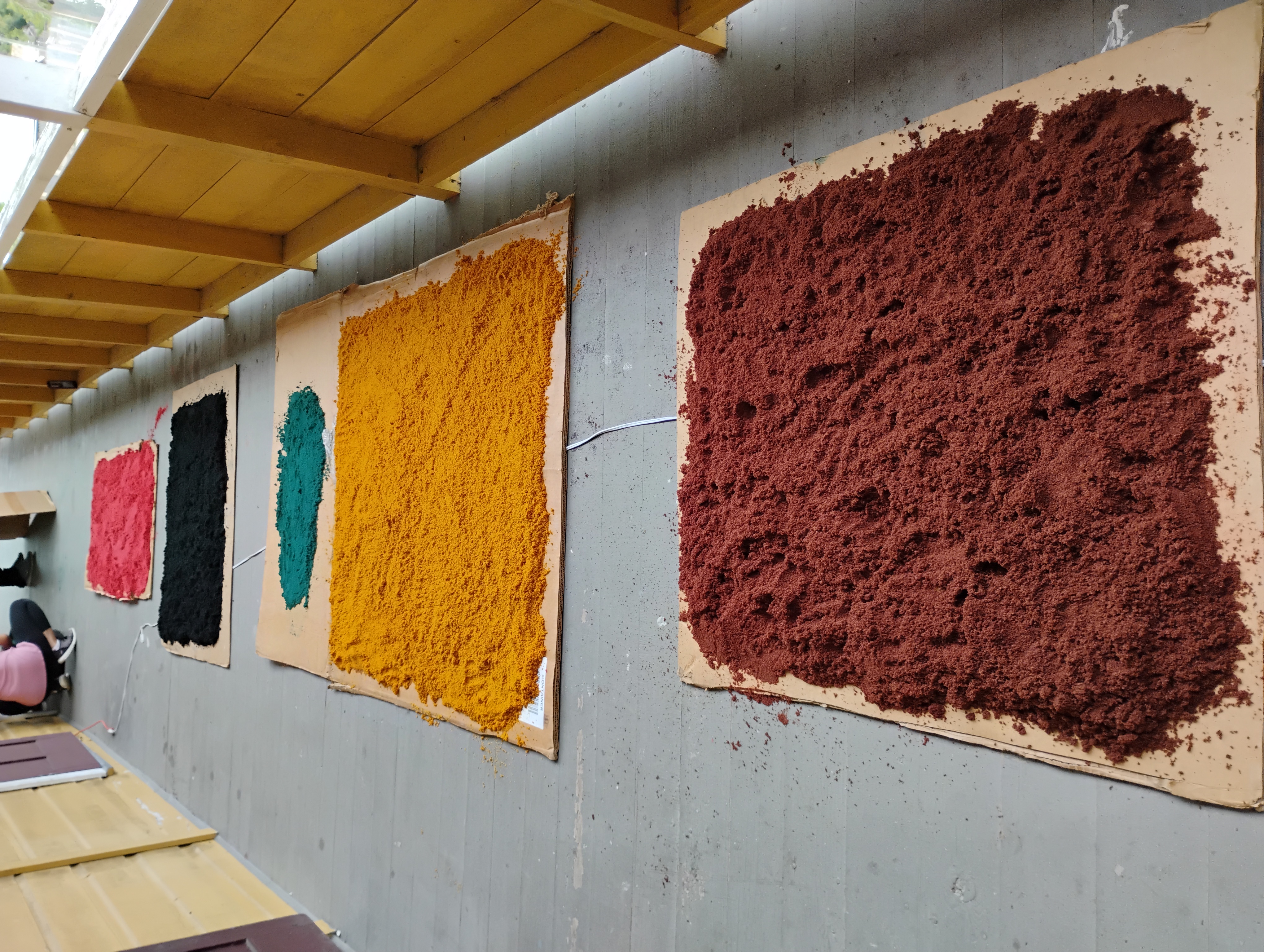 spreading out the dyed sawdust to dry